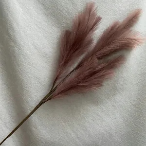 Detailed close-up view of artificial pampas grass faux reed stems for wedding floral decor.