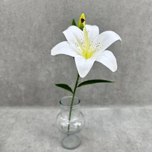 Artificial white lily flower stem in glass vase for wedding and home decor details.