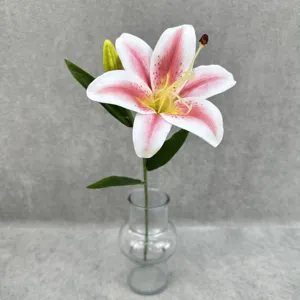 Detailed view of single stem artificial lily flower with pink and white petals and green leaves.