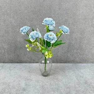 Closeup view of artificial blue peony bouquet details in glass vase for home decoration.