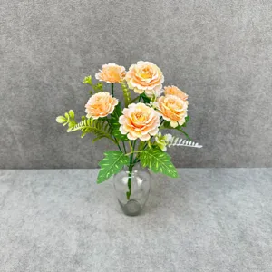Artificial peony flower bouquet detail view with transparent glass vase for home decor setup.