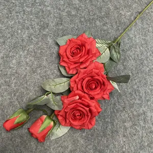 Close-up of artificial red rose flower branch, detailed 3 heads and 2 buds with green leaves.