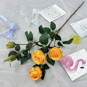 Artificial yellow rose branch with 5 flower heads and green leaves for home and wedding decor.