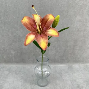 Close-up detail of a single stem artificial lily flower in a clear glass vase, home decor.