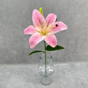 Close-up detail view of single pink lily artificial flower, realistic floral decor piece.