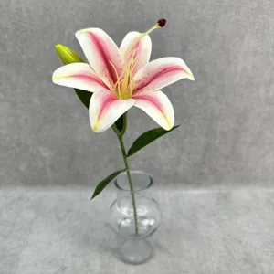 Close-up of a single artificial lily flower in a clear glass vase for elegant home decor.
