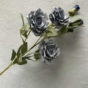Detailed close-up of artificial blue rose flower head, showing realistic petals and texture.