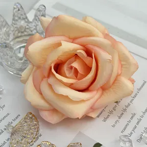 Artificial peach rose flower head, detailed close-up for wedding arch and floral craft decor.