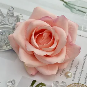 Artificial pink rose flower heads for wedding arch decoration and floral arrangement supplies.