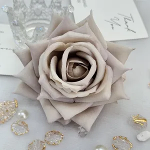 Detailed close-up view of artificial rose flower head craft accessory material design.
