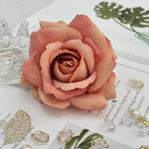 Artificial rose flower head, fabric pink-orange floral material for wedding arch and home party decor.