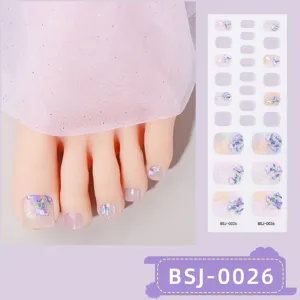 Closeup of semi-cured gel toenail stickers with purple floral design and matching sheet.