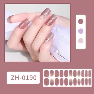 Waterproof nail wraps detail view showing gradient pink design with golden foil and stars.