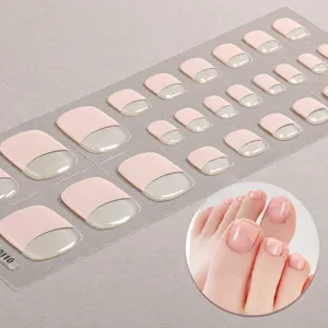 Detailweergave van roze Franse semi-geharde gel teen nagelstrips met glanzende afwerking.