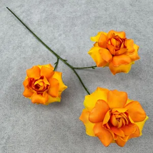 Close-up detail of a 3-head artificial rose branch with gradient orange petals for decor.