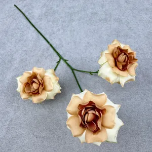 Detailed close-up shot of artificial champagne rose flower branch featuring three blooming heads.