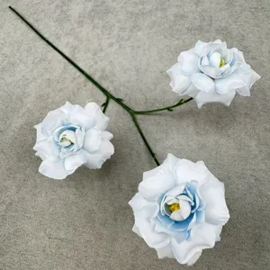Close-up detail of artificial rose flower branch with three blue gradient heads and stem.