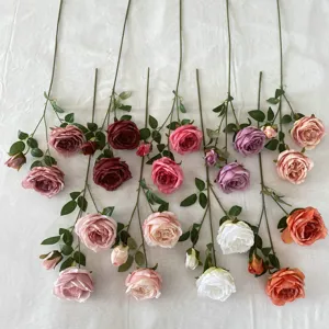 Detailed close-up of artificial Austin rose bouquets, fabric flower heads with long stems.