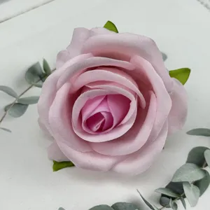 Close-up detail of artificial pink velvet rose flower head for wedding decoration and crafts.