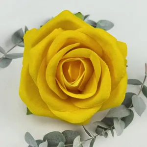 Yellow velvet artificial rose flower head close-up detail, perfect for wedding floral decor.
