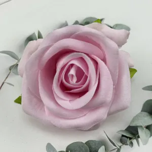 Artificial pink velvet rose flower head for wedding decoration and floral wall crafting.