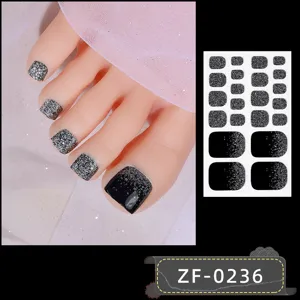Close-up details of black silver glitter gradient toenail wraps sheet with mannequin foot display.