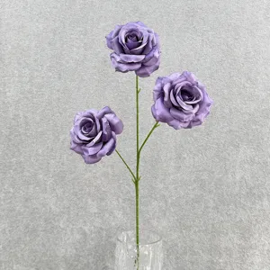 Detail shot of artificial purple rose stem featuring three silk flower heads in a vase.
