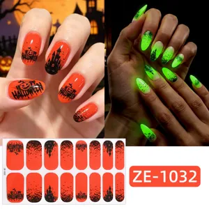 Halloween glow-in-the-dark nail wraps detail view, featuring spooky castle and pumpkin designs.