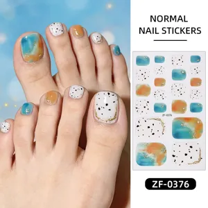 Adhésifs pour ongles d'orteils d'été dégradés avec des pois bleus et de la feuille d'or.