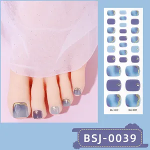 Detailed view of semi-cured gel toenail stickers featuring blue gradient and gold foil art.