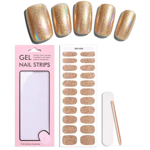 Set di strisce per unghie in gel glitter oro con confezione e strumenti per manicure.