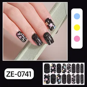 Detailed view of black glitter floral nail wraps 16pcs set, showing hand application effect.
