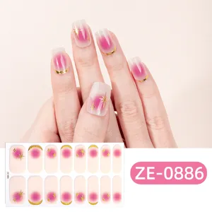 Gradient pink French nail wraps featuring elegant gold star and moon foil accents.