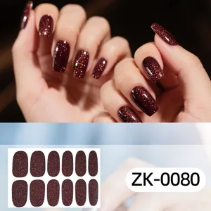 Detailed view of dark brown glitter nail stickers showing shimmering texture and close up.