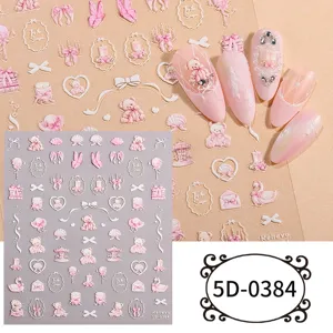 5D embossed nail art sticker detail showing cute pink bear bow and candle relief elements.