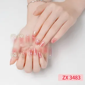 Close-up detail of pink and gold glitter nail wraps with cute star accents for stylish manicures.