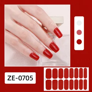 Vue détaillée d'ongles autocollants pailletés rouges avec des strass et des échantillons.