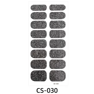 Black glitter nail wraps detail showing fine silver sparkle on oval black stickers sheet.