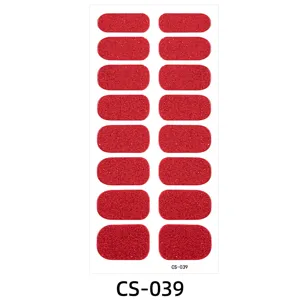 Red glitter nail wraps detail showing sparkling texture and various sizes for manicure art.