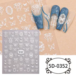 Close up detail of 5D embossed white lace butterfly nail stickers with finished display nail tips.