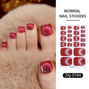 Close-up detail of glittering cat-eye toenail stickers with stunning red sparkle design.