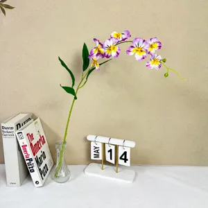 Artificial phalaenopsis orchid flower detail, elegant purple silk floral decor for home interior.