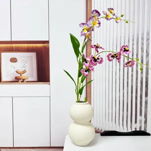Artificial Phalaenopsis floral arrangement in white vase for home living room decor.