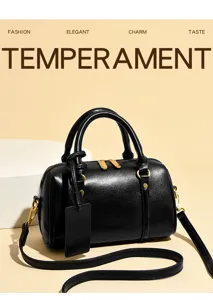 Black leather Boston bag with gold-tone hardware, top handle, and adjustable strap. Chic style.