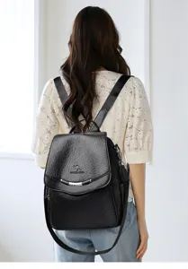 Black leather casual backpack for women, stylish travel daypack with secure flap and straps.