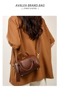 Solid color leather small boston bag, retro pillow crossbody bag for women, stylish daily use.