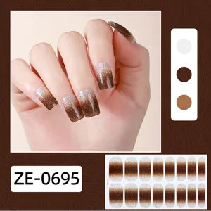 Nahaufnahme von braunen Glitzer-Farbverlauf-Nagelaufklebern mit Farbpalette und Bogen.
