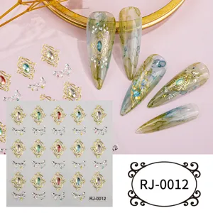 Close-up detail of 5D relief golden baroque gemstone nail art stickers with crystal rhinestones.