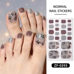 Detailed view of pink glitter and floral toe nail stickers sheet with application on feet.