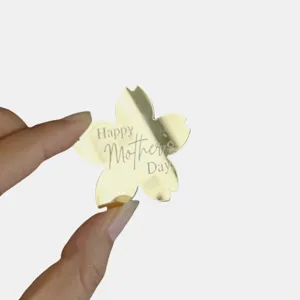 Gold acrylic flower cake topper engraved with Happy Mothers Day for celebration events.